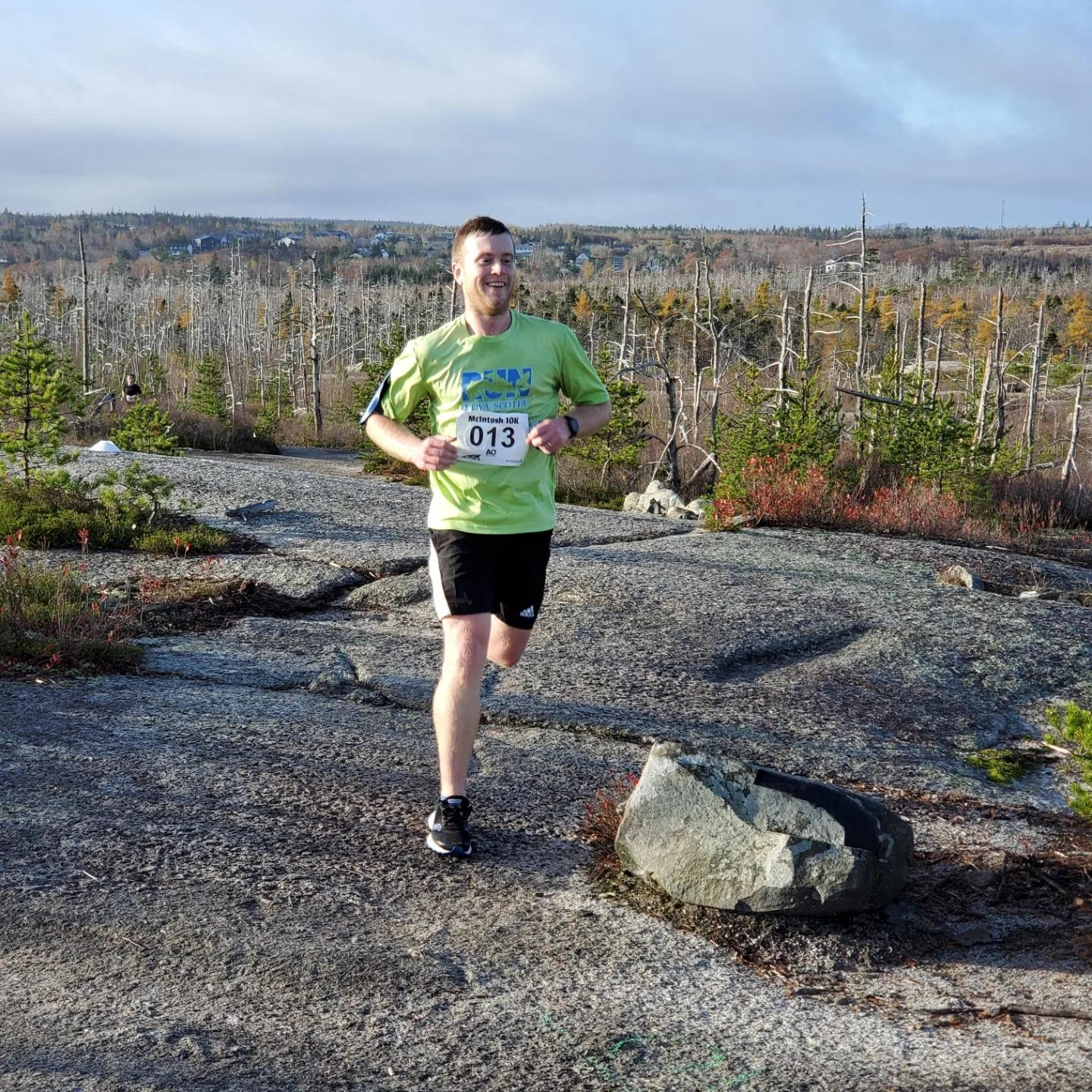Brenden running on a gravel trail with trees in the background. Brenden running on a gravel trail with trees in the background.